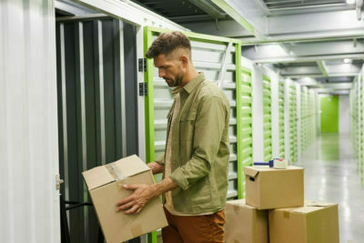 a man holding a box in a warehouse