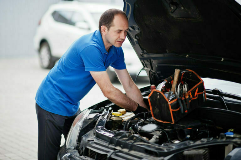 a man fixing a car