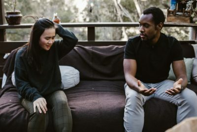 a man and woman sitting on a couch
