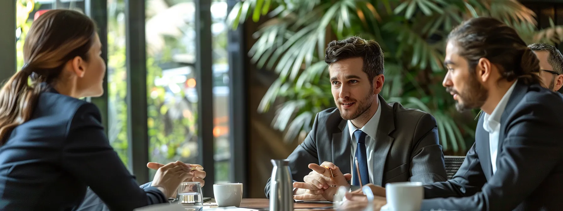 a group of business professionals gathered around a table, discussing the benefits of selling a house quickly in puyallup, wa.